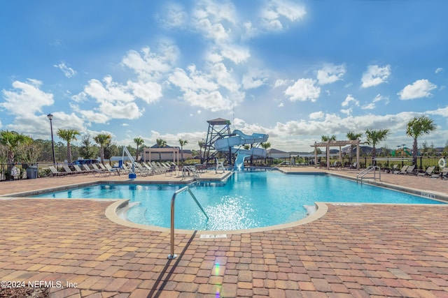 view of pool with a patio and a water slide