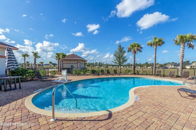 view of swimming pool featuring a patio area