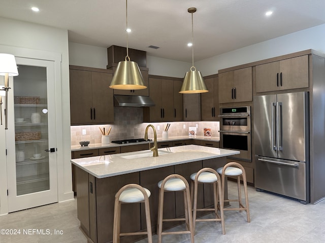 86 Delwood Way Unit 269, Saint Augustine, FL 32092 - kitchen featuring light stone countertops, decorative light fixtures, backsplash, stainless steel appliances, and a center island with sink