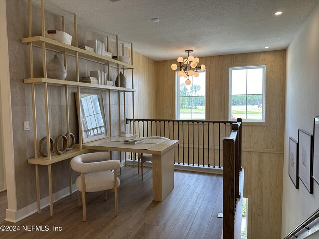 86 Delwood Way Unit 269, Saint Augustine, FL 32092 - dining area with wood-type flooring, a textured ceiling, and a notable chandelier