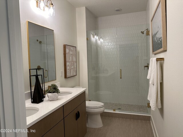 86 Delwood Way Unit 269, Saint Augustine, FL 32092 - bathroom with a textured ceiling, tile patterned floors, vanity, toilet, and walk in shower
