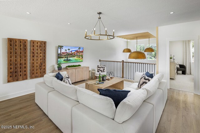 86 Delwood Way Unit 269, Saint Augustine, FL 32092 - living room featuring a notable chandelier, hardwood / wood-style floors, and a textured ceiling