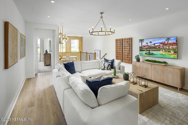 86 Delwood Way Unit 269, Saint Augustine, FL 32092 - living room featuring light hardwood / wood-style floors, a textured ceiling, and an inviting chandelier