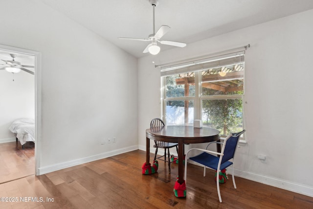 dining room featuring hardwood / wood-style flooring, ceiling fan, a wealth of natural light, and vaulted ceiling