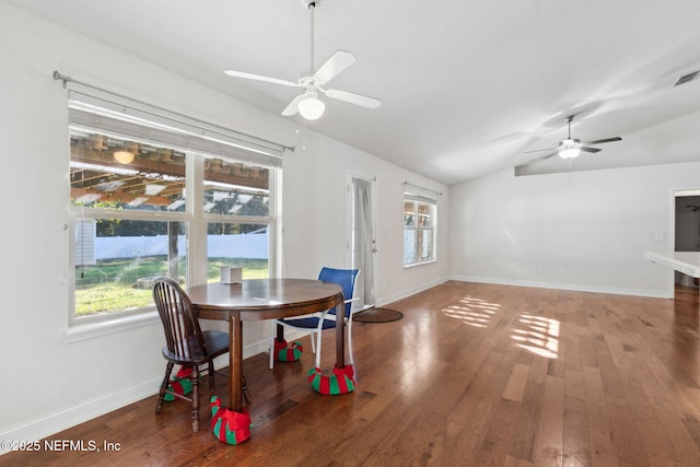 dining space featuring dark hardwood / wood-style floors, ceiling fan, a wealth of natural light, and vaulted ceiling