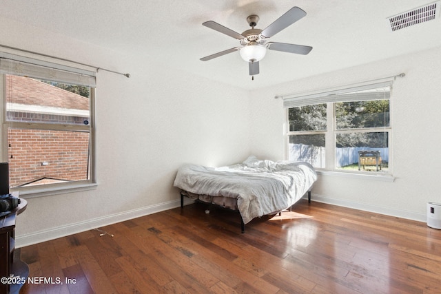 bedroom featuring hardwood / wood-style floors and ceiling fan