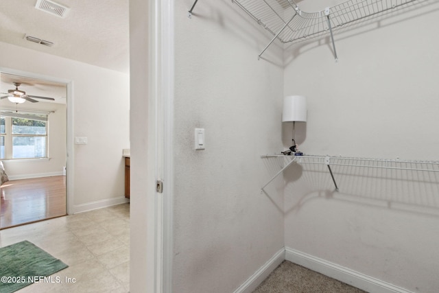 spacious closet with ceiling fan