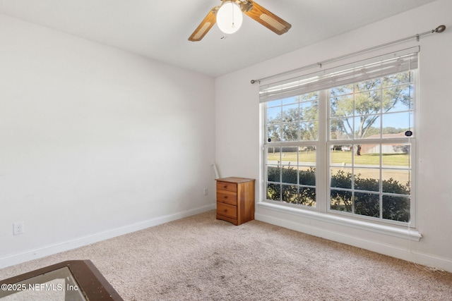 unfurnished room featuring ceiling fan and carpet floors