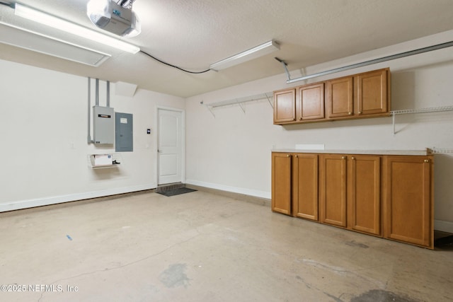 garage featuring electric panel and a garage door opener