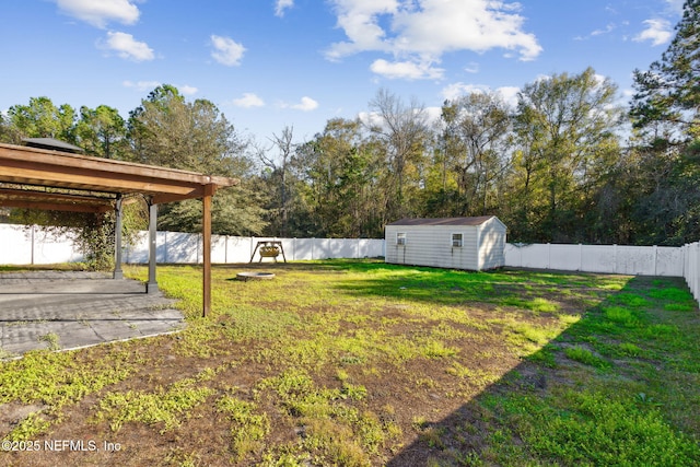 view of yard with a patio and a storage unit