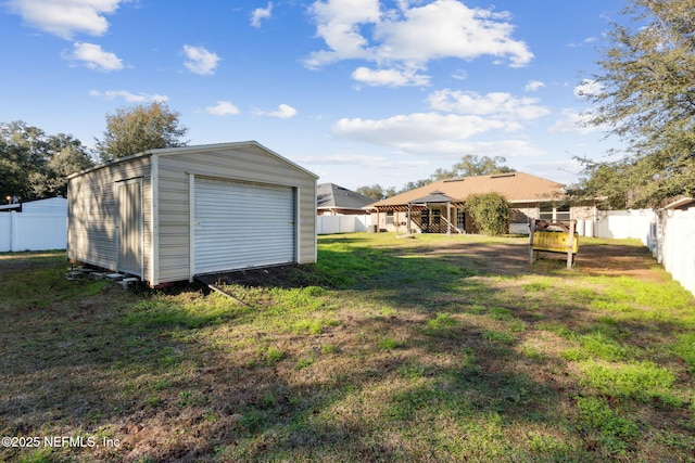 view of yard with a garage and an outdoor structure