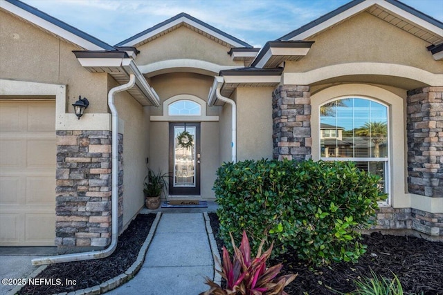 doorway to property with a garage