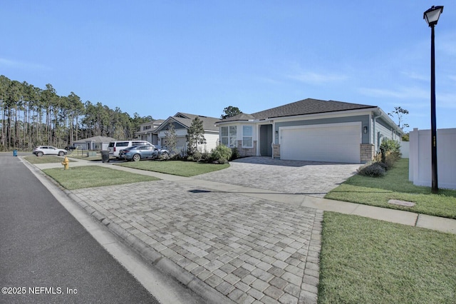 view of front of house featuring a front yard and a garage