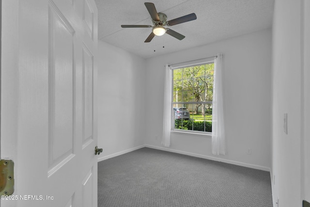 carpeted spare room featuring a textured ceiling and ceiling fan