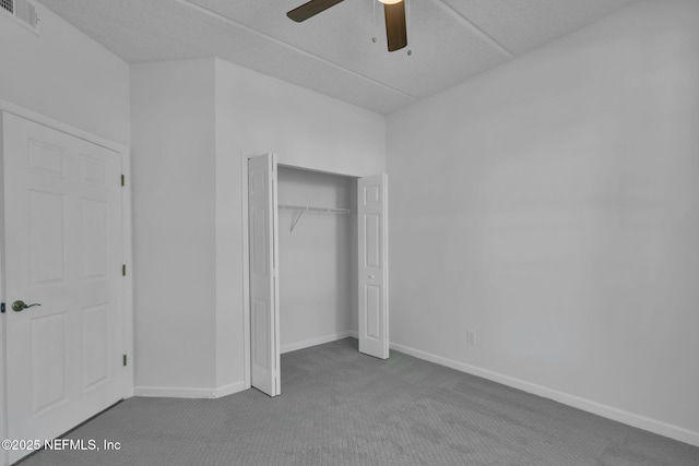 unfurnished bedroom featuring ceiling fan, carpet floors, and a closet