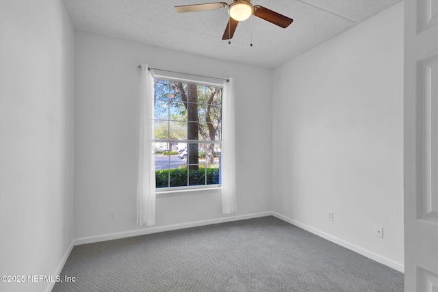 carpeted empty room featuring ceiling fan and a textured ceiling