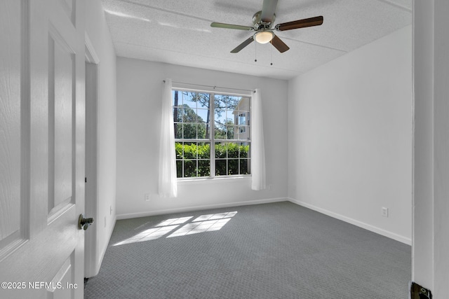 carpeted spare room featuring a textured ceiling and ceiling fan