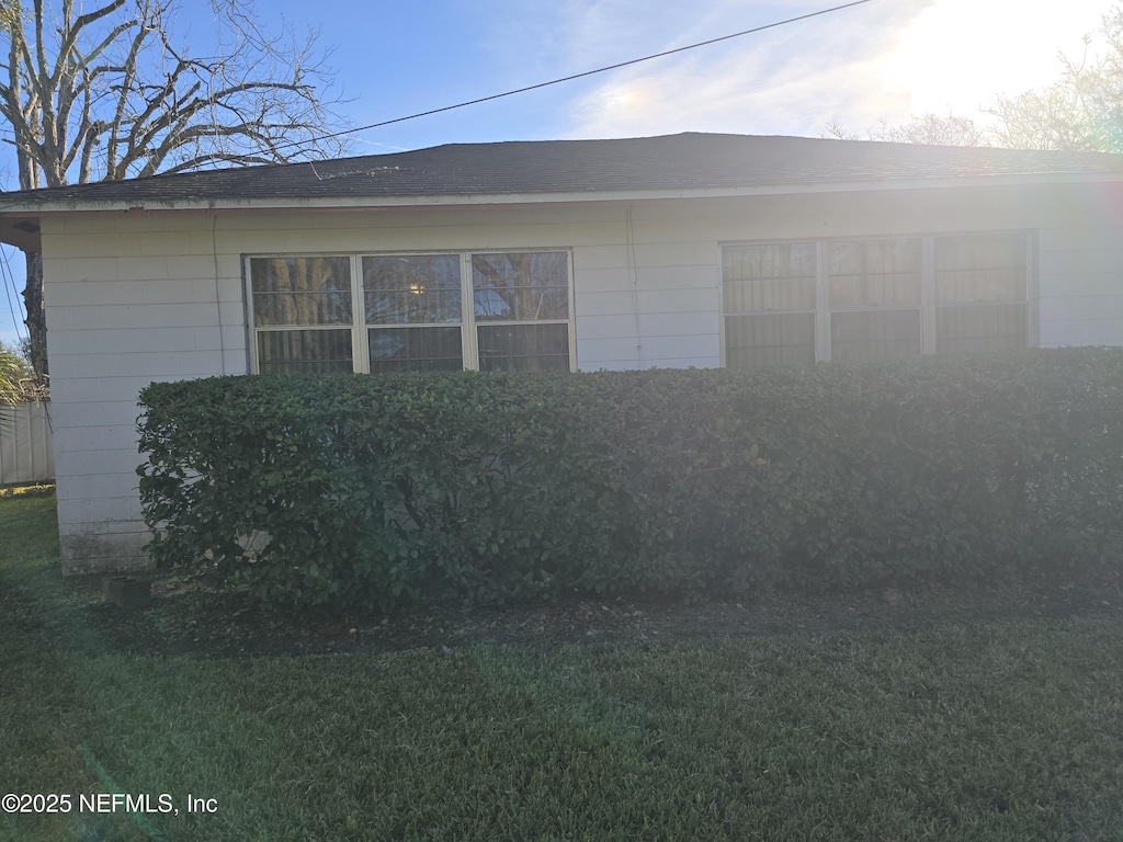 view of side of property with a yard