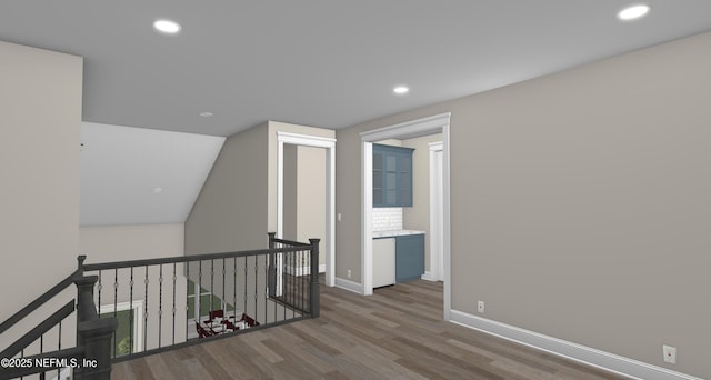 hallway featuring dark hardwood / wood-style flooring and lofted ceiling