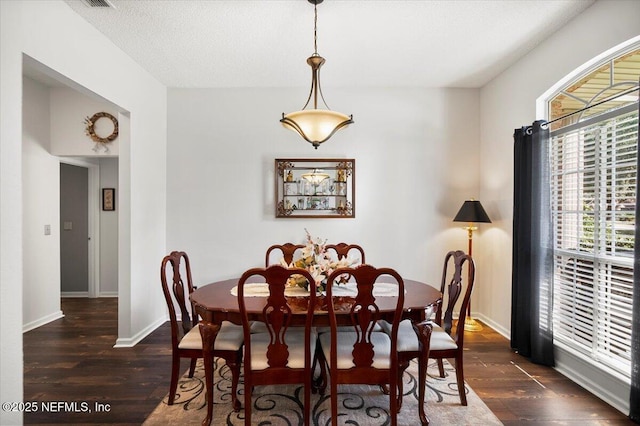 dining space featuring dark hardwood / wood-style flooring