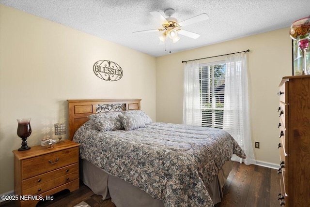 bedroom featuring ceiling fan, dark wood-type flooring, and a textured ceiling