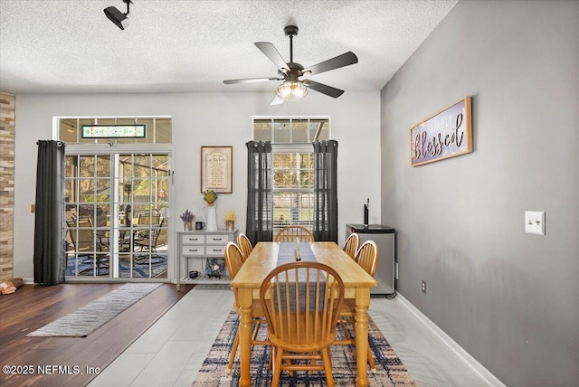 dining room featuring ceiling fan, hardwood / wood-style floors, and a textured ceiling