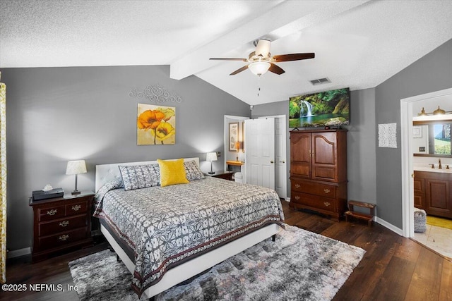 bedroom featuring dark hardwood / wood-style flooring, ceiling fan, sink, connected bathroom, and lofted ceiling