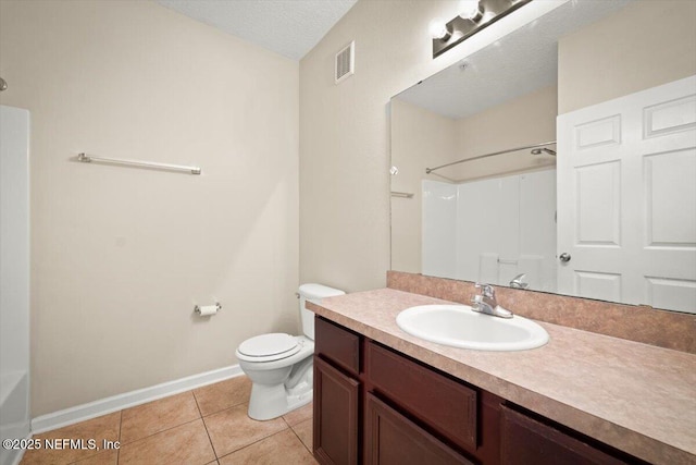 bathroom featuring toilet, tile patterned flooring, a textured ceiling, and vanity