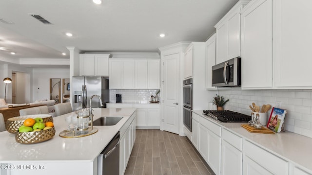 kitchen featuring sink, white cabinets, and appliances with stainless steel finishes