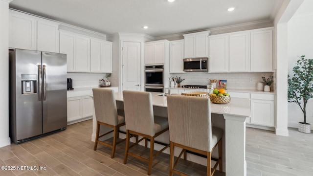 kitchen featuring stainless steel appliances and white cabinets