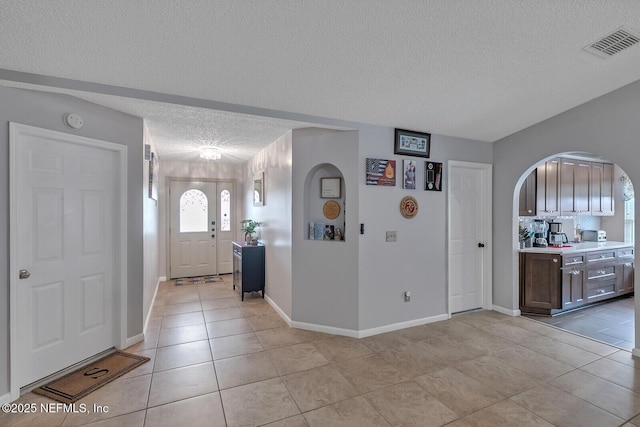 kitchen featuring a textured ceiling and light tile patterned flooring