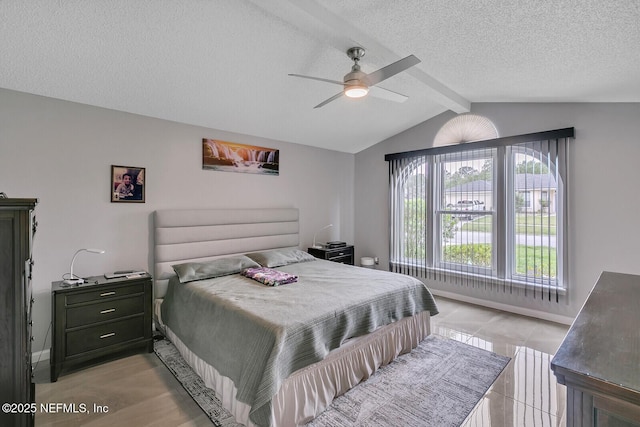 bedroom featuring vaulted ceiling with beams, ceiling fan, light tile patterned floors, and a textured ceiling