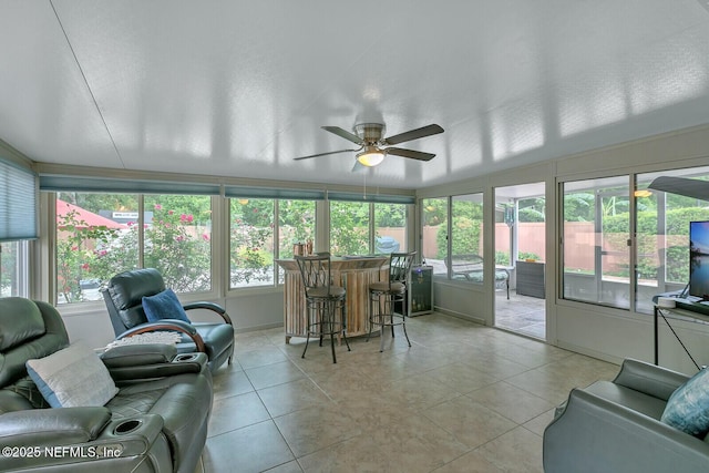 sunroom / solarium with bar area and ceiling fan