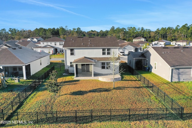 back of property featuring a lawn and a patio