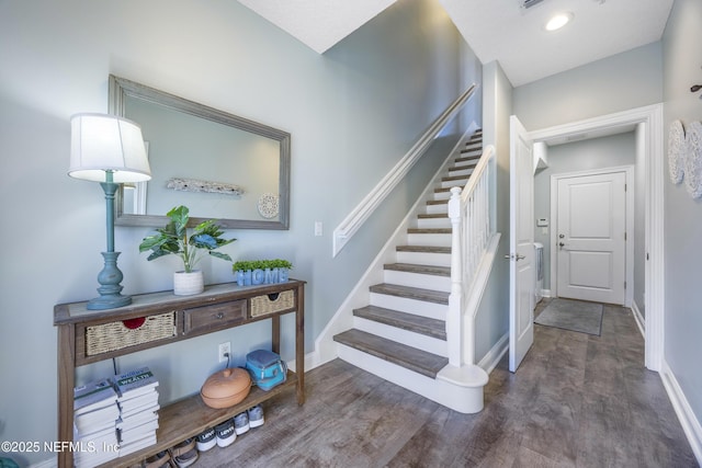 stairs featuring wood-type flooring