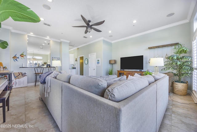 living room featuring ceiling fan, ornamental molding, and light tile patterned flooring