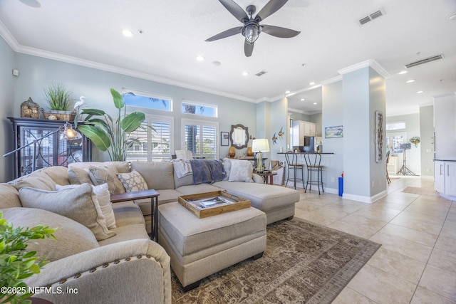 tiled living room featuring crown molding and ceiling fan