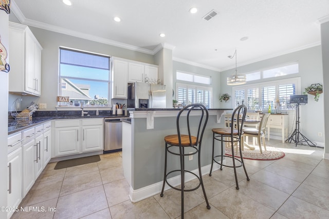 kitchen featuring a kitchen island, white cabinetry, and appliances with stainless steel finishes