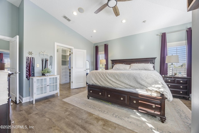 bedroom with multiple windows, ceiling fan, and high vaulted ceiling