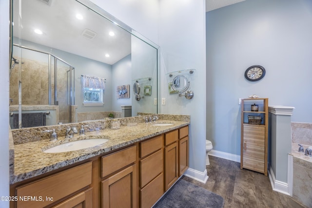 full bathroom with independent shower and bath, vanity, wood-type flooring, and toilet