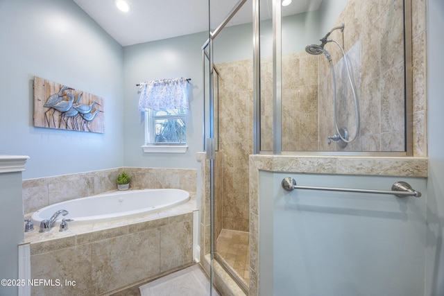 bathroom featuring independent shower and bath