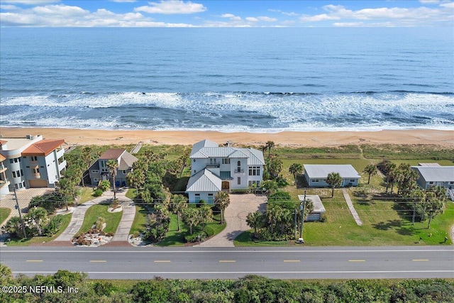 birds eye view of property featuring a view of the beach and a water view