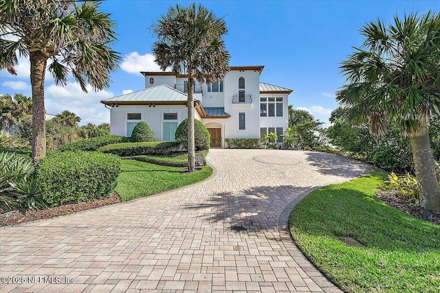 mediterranean / spanish home featuring a front lawn