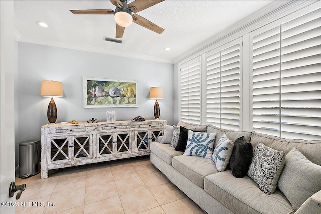 tiled living room featuring ceiling fan and ornamental molding