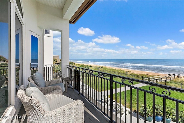 balcony featuring a water view and a view of the beach