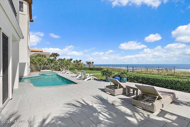 view of swimming pool with a patio area, an in ground hot tub, and a water view