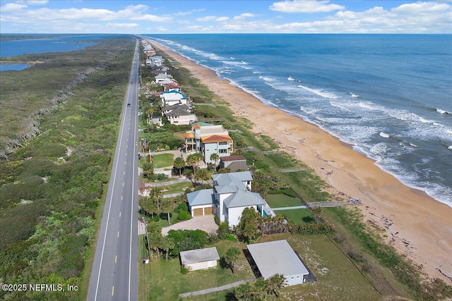 aerial view with a water view and a beach view