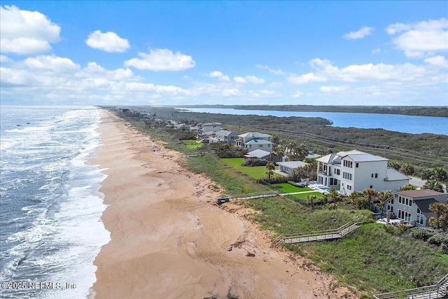 drone / aerial view featuring a beach view and a water view