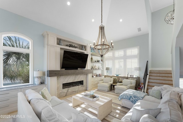 living room with a fireplace and a chandelier