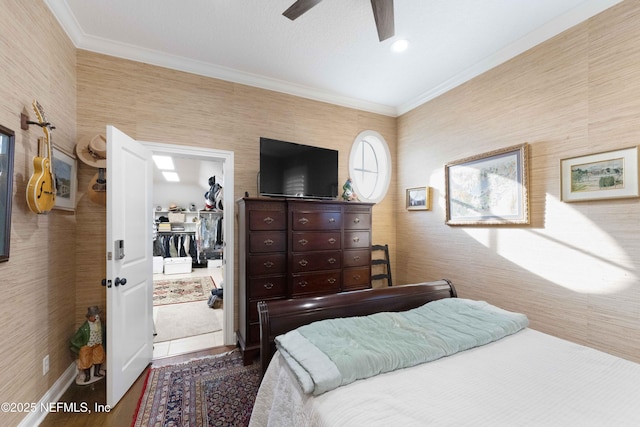 bedroom with ceiling fan, hardwood / wood-style floors, and ornamental molding